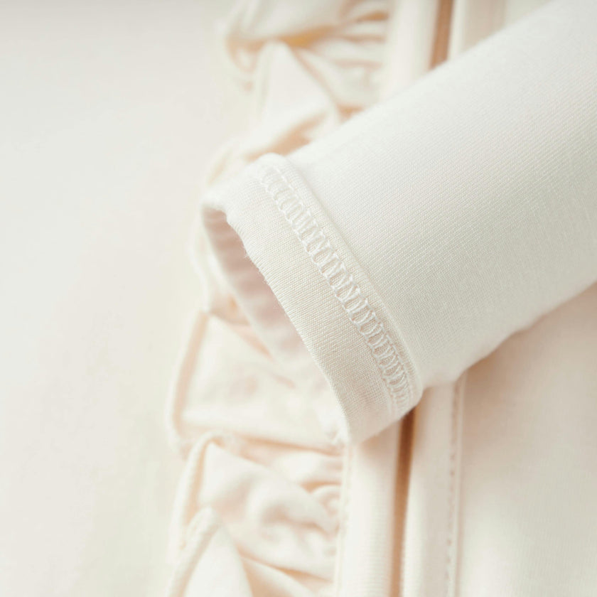 Salt Luxe Solid Ruffle Footed Romper