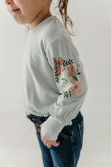 Girls Ruffle Hem Sweatshirt in Floral Sleeves in Misty Blue