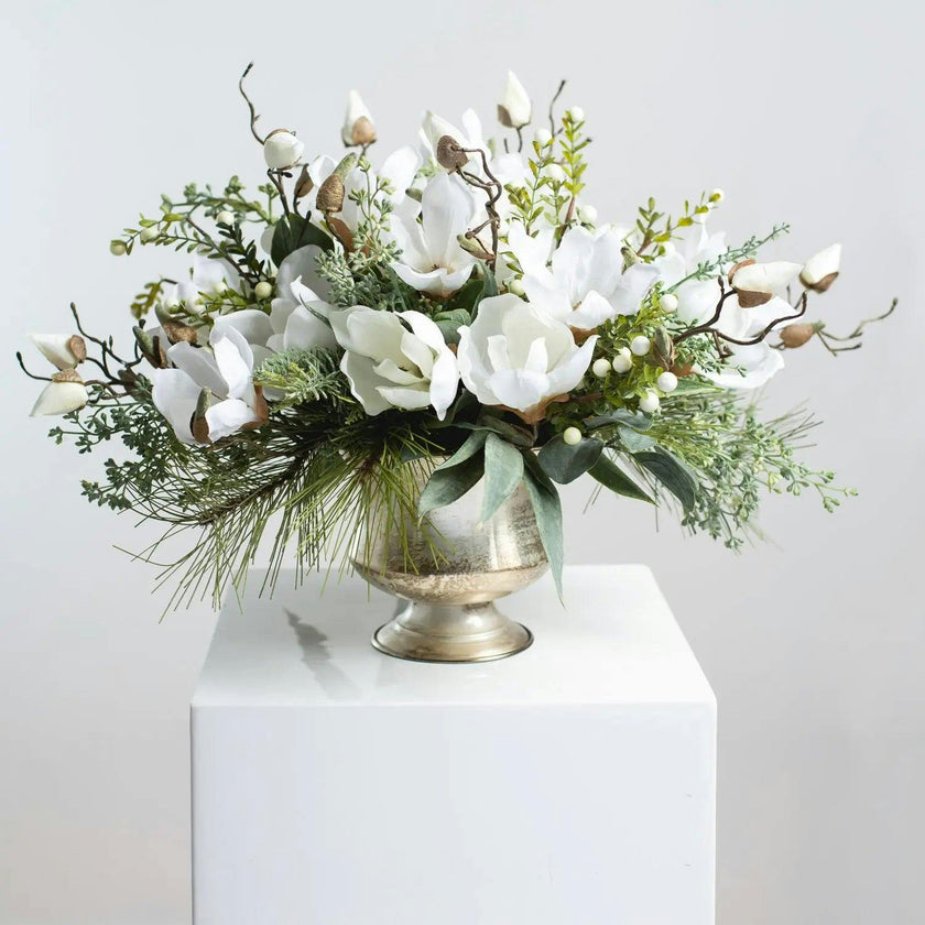 Winter White Magnolia, Pine & Snowberry Christmas Arrangement Centerpiece in Antiqued Silver Metal Urn