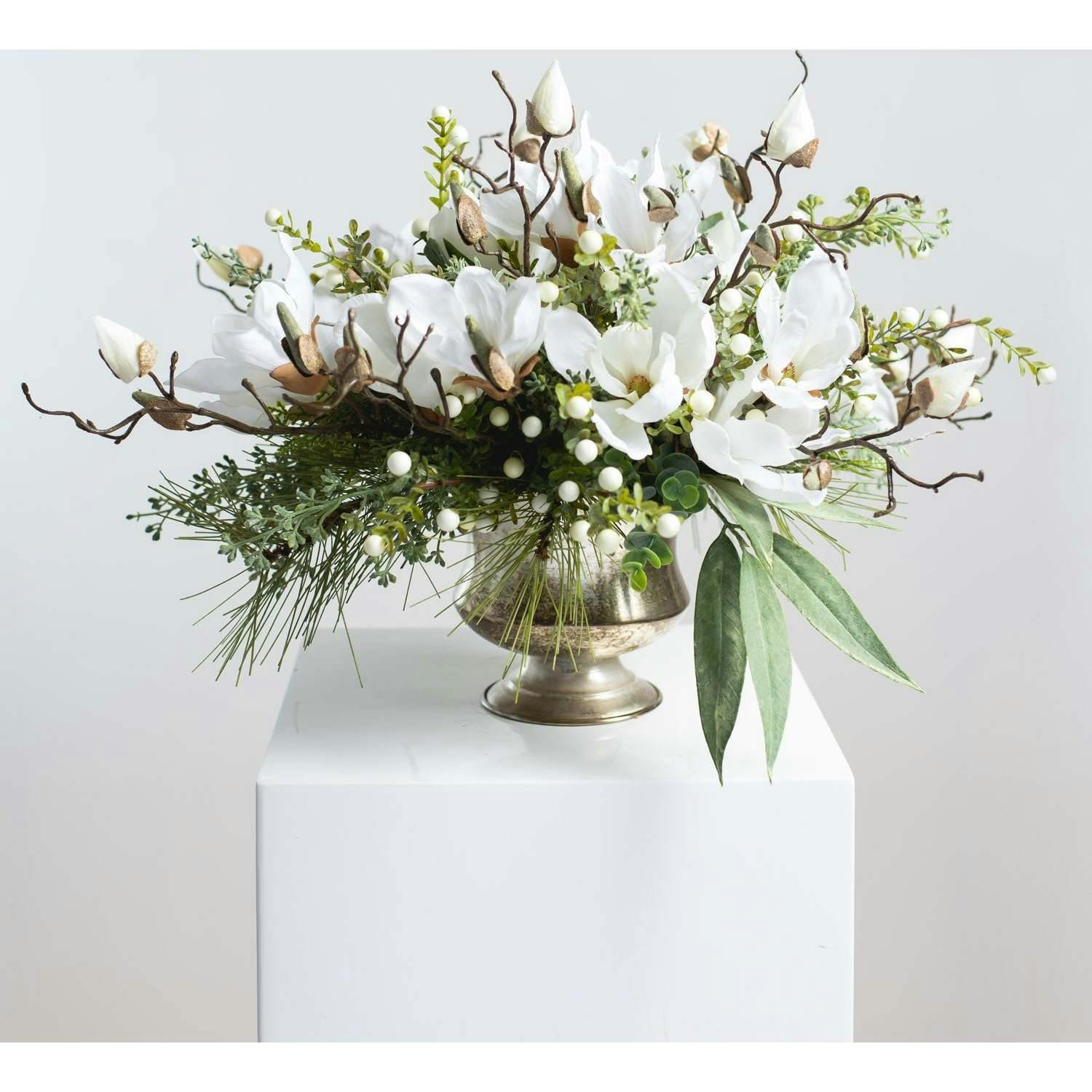 Winter White Magnolia, Pine & Snowberry Christmas Arrangement Centerpiece in Antiqued Silver Metal Urn
