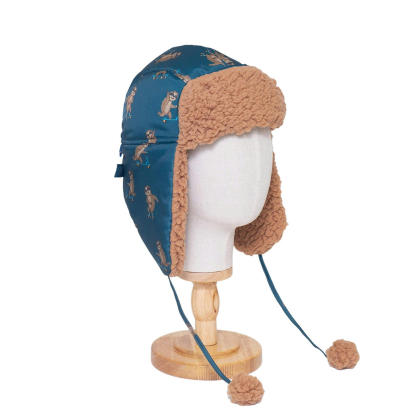 The Cozy Trapper Hat – Skating Sloths Print with Curry Tan Sherpa Liner & Pompoms