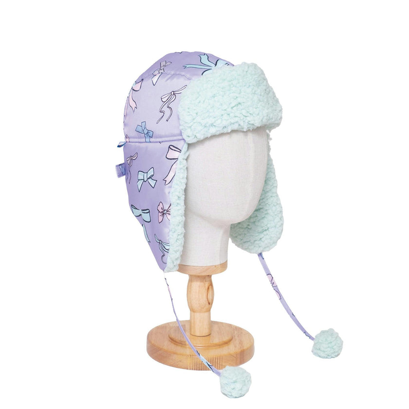 The Cozy Trapper Hat – Bows Print with Pale Aqua Sherpa Liner & Pompoms