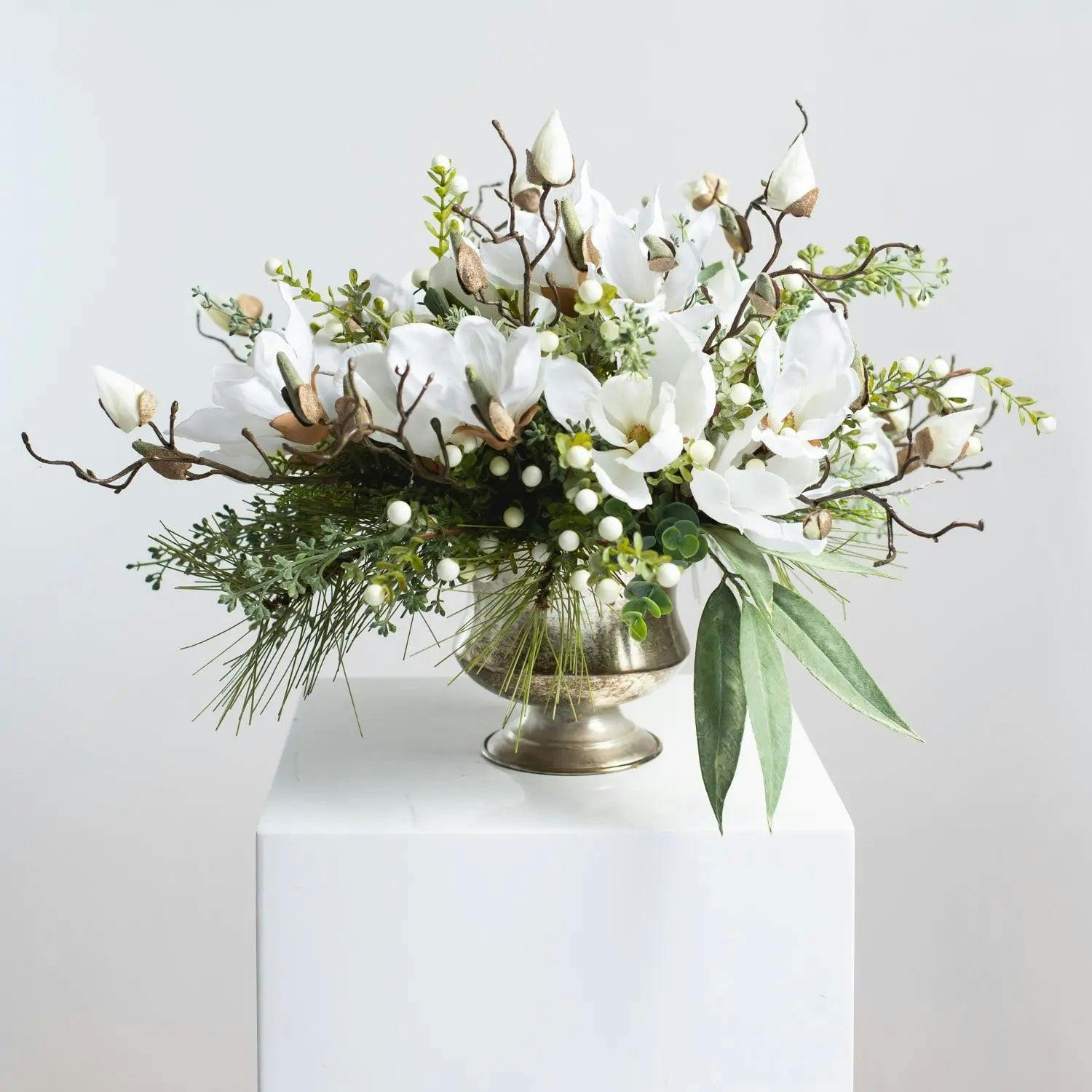 Winter White Magnolia, Pine & Snowberry Christmas Arrangement Centerpiece in Antiqued Silver Metal Urn