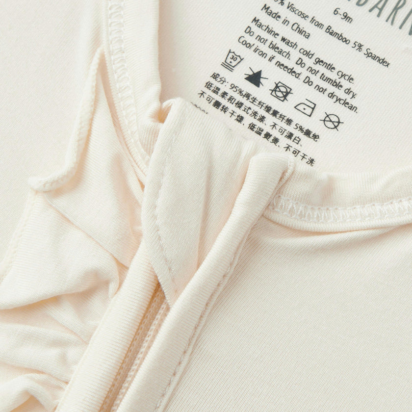 Salt Luxe Solid Ruffle Footed Romper