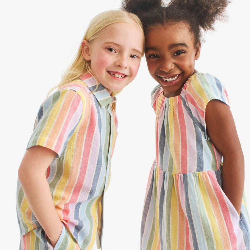Kids cotton gauze boardwalk dress in rainbow stripe
