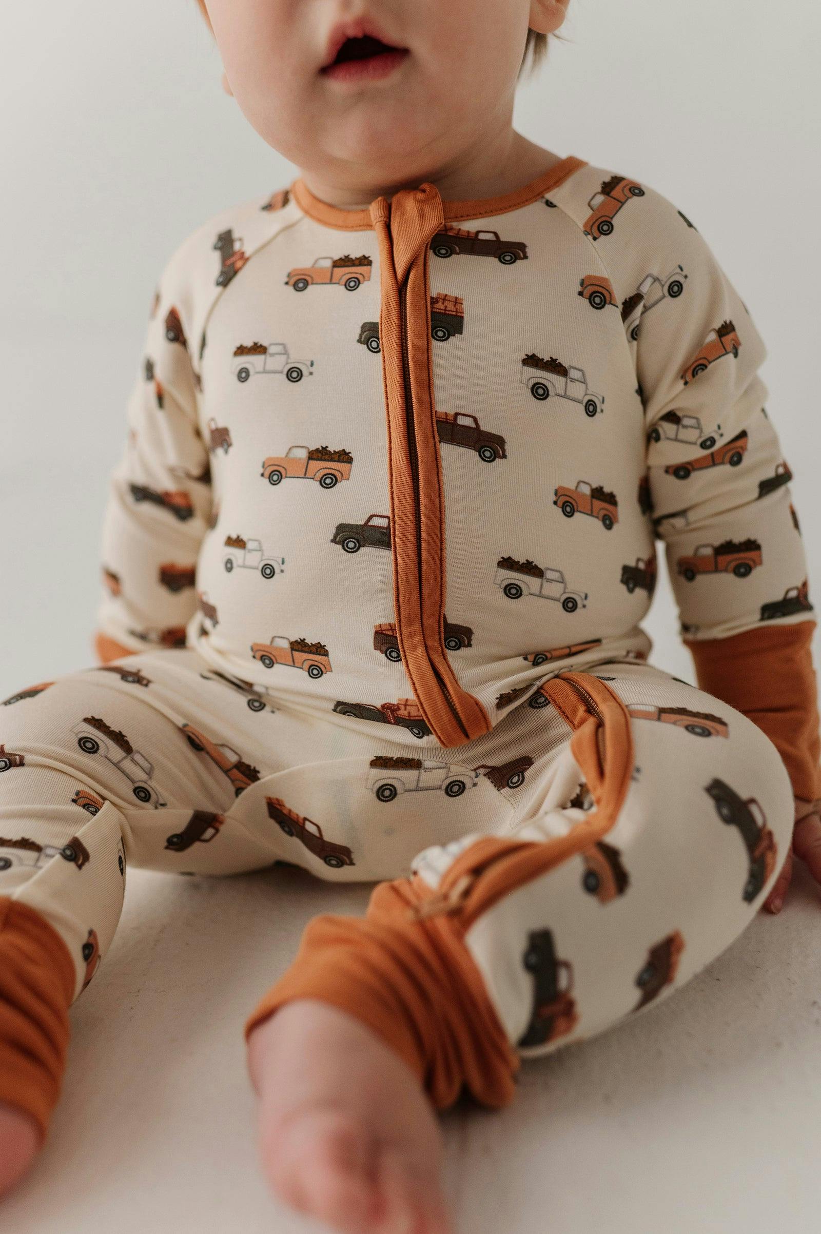 Baby Boy Long Sleeve Zip Romper in Pumpkin Trucks